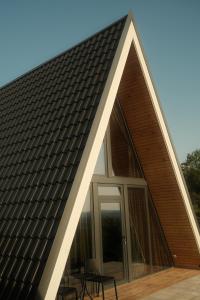 a house with a triangular roof with a window at Homoljski Vidikovac in Ždrelo