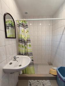 a bathroom with a sink and a shower curtain at Pokoje gościnne Edan in Łeba +43 photos