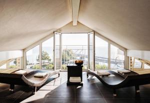 a large room with large windows and tables and chairs at Seehotel Litz in Langenargen