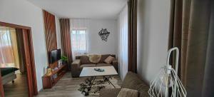 a living room with a couch and a table at Apartment FIMM in Veľká Lomnica