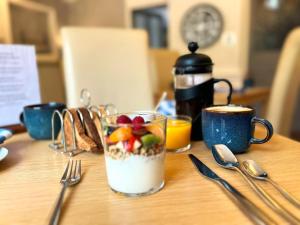 a table with a glass of milk with fruit in it at Eagle View Guest House in Newtonmore +31 photos