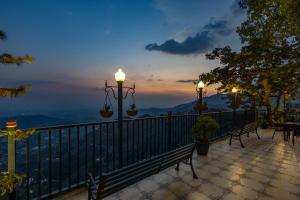 a balcony with a view of the ocean at night at Jharipani Castle in Mussoorie