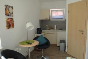 a small kitchen with a table and two chairs at Ferienquartier Trassenheide 1 in Trassenheide
