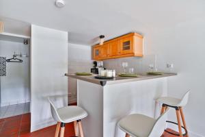 a small kitchen with two stools and a counter top at Welcome to Chic Duplex in Wissous +8 photos