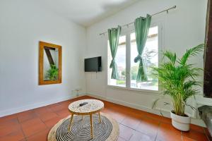 a living room with a table and a window at Welcome to Chic Duplex in Wissous
