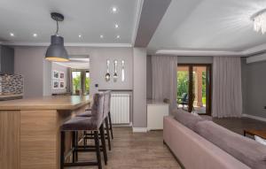 a kitchen and living room with a couch and a bar at 4 Bedroom Beautiful Home In Kostrena in Kostrena
