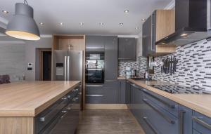 a kitchen with a stainless steel refrigerator and a counter at 4 Bedroom Beautiful Home In Kostrena in Kostrena