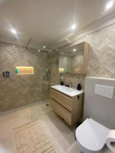 a bathroom with a toilet and a sink and a shower at Miraflores Beach & Country Club in Mijas Costa