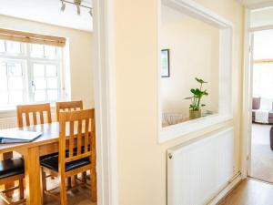 a dining room with a table and a mirror at Herons Lodge in Abergavenny +1 photo