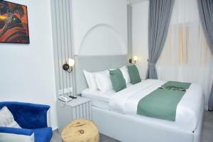 A bed or beds in a room at The Hague Maitama