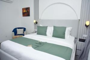 A bed or beds in a room at The Hague Maitama