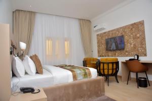 A bed or beds in a room at The Hague Maitama