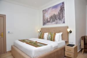 A bed or beds in a room at The Hague Maitama