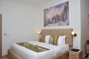 A bed or beds in a room at The Hague Maitama