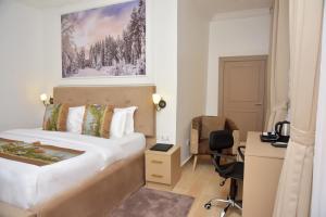 A bed or beds in a room at The Hague Maitama