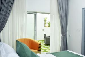 A bed or beds in a room at The Hague Maitama