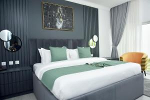 A bed or beds in a room at The Hague Maitama