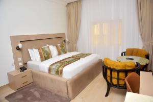 A bed or beds in a room at The Hague Maitama