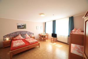 a bedroom with a bed and a table in it at Café am Donautor in Kelheim