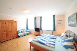 a bedroom with a bed and a couch at Café am Donautor in Kelheim