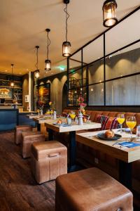 a restaurant with tables and chairs and a bar at City Center Lodge Utrecht in Utrecht