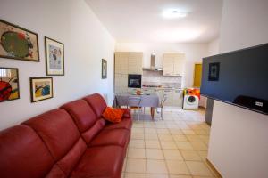a living room with a brown couch and a table at Blue Beach - New House near Sea in Nardò