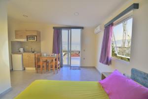 a room with a bed and a kitchen with a table at Callista sea view or garden in Kissamos