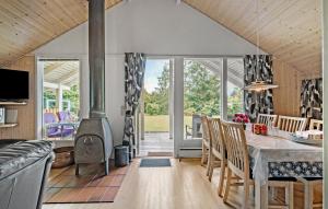 a kitchen and dining room with a wood stove at Cozy Home In Fårvang With Wifi in Fårvang