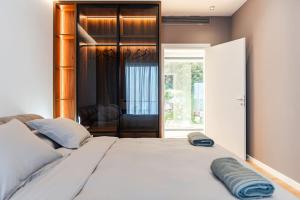 a bedroom with a large white bed with a phone on it at Villa Serenity Luxury Lakeside Manor in Široka +33 photos