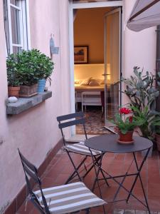 a patio with a table and two chairs and a table at Casa Agostino Codazzi Dimora storica in Lugo