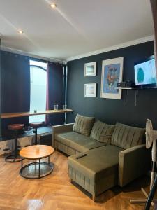 a living room with a couch and a table at Apartament Gold 4 in Złotoryja +3 photos