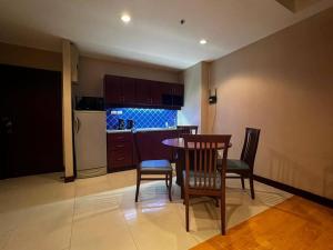 a kitchen with a table and chairs in a room at Patong Tower Apartment - AMP in Patong Beach