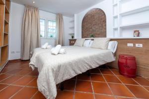 a bedroom with a large bed with white pillows at Calas Beach Corralejo in Corralejo