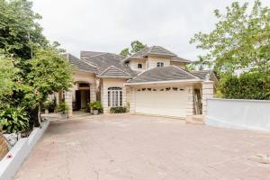 a large house with a garage in front of it at Idilio Escape in Ocho Rios