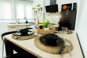 una cucina con tavolo, piatti e utensili di La palmera apartment a Santander