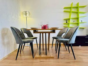 a dining room table with four chairs around it at Joy City Stay Forest 84 in Timişoara +62 photos