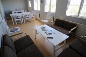 a living room with couches and a table and a dining room at STF Bunge Hostel in Fårösund