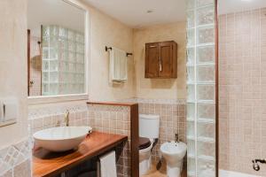 a bathroom with a sink and a toilet at Casa rural con jacuzzi en centro histórico de Pals in Pals +50 photos