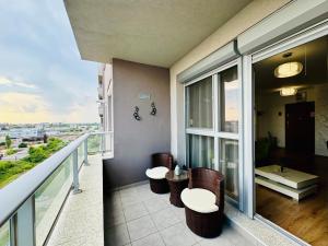 a balcony with a table and chairs on a building at Joy City Stay Forest 84 in Timişoara