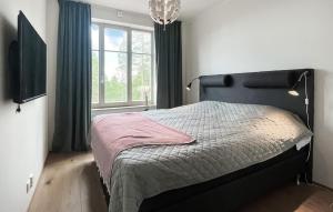 a bedroom with a bed with a large window at Cozy Apartment In Idre With Sauna in Idre