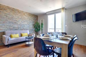 a living room with a table and chairs and a couch at Welcome to Stella's House in Montgeron