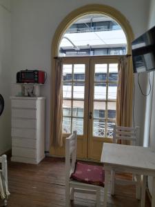 a room with a table and chairs and a window at Casa de Huéspedes Cristina Recoleta Cristina Guesthouse Recoleta in Buenos Aires +5 photos
