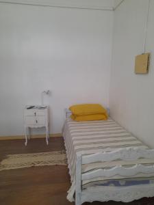 a small bedroom with a bed and a night stand at Casa de Huéspedes Cristina Recoleta Cristina Guesthouse Recoleta in Buenos Aires