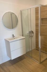 a bathroom with a sink and a mirror at Rato in Murter +47 photos