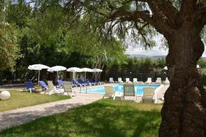 a swimming pool with lounge chairs and umbrellas at Dory by Penta Dream House in Campofelice di Roccella