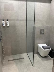 a shower stall with a toilet in a bathroom at Thess Living Suites in Thessaloniki