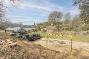 two cars parked in front of a soccer goal at Cal Sastre in Biscarri