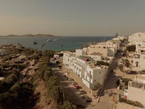 an aerial view of a city with buildings and the water at Opal Paros in Naousa