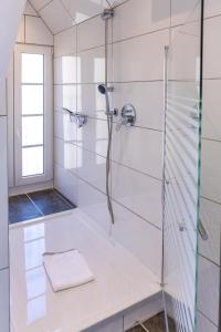 a bathroom with a shower with a glass door at Ferienhaus Moselherz in Merl +70 photos
