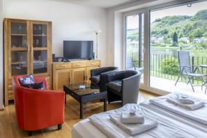a living room with two beds and a television at Ferienhaus Moselherz in Merl